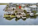 Aerial shot of a waterfront home with a private dock, decks, and lush landscaping at 337 59Th Ave. N, North Myrtle Beach, SC 29582