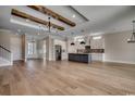 Expansive living space with wood floors, beamed ceilings, and a modern kitchen with a large island at 404 Plantation Oaks Dr., Myrtle Beach, SC 29579