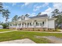 Charming single-story home with a spacious front porch, beautiful landscaping, and inviting curb appeal at 4074 Center Rd., Georgetown, SC 29440