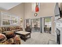 Spacious living room showcasing a high ceiling, slider doors, and comfortable seating at 4355 Willoughby Ln. # 401, Myrtle Beach, SC 29577