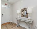 Bright entryway with a light gray console table, decorative mirror, and two stylish white lamps at 489 Blissful Ln., Little River, SC 29566