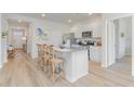 Open kitchen featuring white cabinets, granite countertops, and an island with bar stool seating at 489 Blissful Ln., Little River, SC 29566
