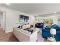 Bright living room with hardwood floors, stylish furniture, and large windows offering plenty of natural light at 57 Eagle Claw Dr., Carolina Shores, NC 28467