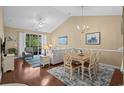 Cozy living room with hardwood floors, vaulted ceiling, and access to a balcony at 6015 Catalina Dr. # 332, North Myrtle Beach, SC 29582