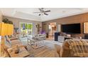 Spacious living room with tray ceiling, ceiling fan and sliding glass door at 605 Cavandish Dr., Myrtle Beach, SC 29588