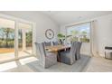 Bright dining room with sliding doors, large windows, modern decor, and a view of the outdoor space at 7119 Shooting Star Way, Myrtle Beach, SC 29579