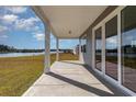 View from covered back porch with ceiling and view of grassy yard and lake at 748 Choctaw Dr., Conway, SC 29526