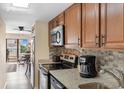Bright kitchen has granite countertops, wood cabinets, and stainless steel appliances at 7509 N Ocean Blvd. # 404, Myrtle Beach, SC 29572