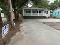 Attractive single-story house with 'For Sale' sign, showcasing its appealing curb appeal and ample parking at 803 34Th Ave. S, North Myrtle Beach, SC 29582