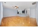Open concept living room with hardwood floors, a ceiling fan, and a view into the updated kitchen at 854 Falkirk St., Myrtle Beach, SC 29579