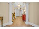 Inviting hallway with decorative pillars, tiled floor, and warm lighting, leading to the front door at 8546 San Marcello Dr. # 1-102, Myrtle Beach, SC 29579