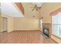 Inviting living room featuring hardwood floors, a cozy fireplace, and a ceiling fan at 934 Tiffany Ln., North Myrtle Beach, SC 29582