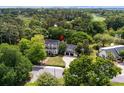 An aerial view of a charming home nestled among trees, close to a golf course at 9340 Lake Dr., Myrtle Beach, SC 29572