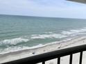 Breathtaking ocean view from the balcony, with white sand beaches and gentle waves at 9500 Shore Dr. # 17B, Myrtle Beach, SC 29572