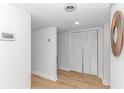 Clean hallway features white trim, wood-look floors, closet, and stylish circular wall art at 9551 Edgerton Dr. # C-6, Myrtle Beach, SC 29572