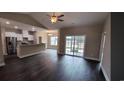 Bright living room open to the kitchen, featuring hardwood floors and a ceiling fan at Tbd 80 Persimmon Rd., Aynor, SC 29511