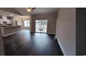 A spacious living room featuring hardwood floors and a sliding glass door at Tbd 82 Persimmon Rd., Aynor, SC 29511