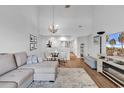 Bright living room with vaulted ceilings, a decorative fireplace, modern furniture, and open to the kitchen at 1100 Possum Trot Rd. # D-205, North Myrtle Beach, SC 29582