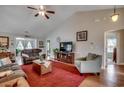 Bright living room featuring neutral walls, hardwood floors, ceiling fan, and comfortable seating at 113 Camrose Way, Myrtle Beach, SC 29588