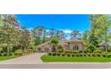 Charming home surrounded by vibrant landscaping and a well-manicured lawn with mature trees at 1206 Spinnaker Dr., North Myrtle Beach, SC 29582