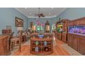 Cozy living room features hardwood floors, tray ceilings, and a decorative ceiling fan at 1206 Spinnaker Dr., North Myrtle Beach, SC 29582