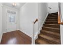 Inviting foyer with wood floors, staircase, and decorative glass door leading to the home at 122 Parmelee Dr. # A, Murrells Inlet, SC 29576