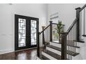 Bright entryway featuring modern doors, staircase with dark wood steps, and stylish decor at 1279 Fiddlehead Way, Myrtle Beach, SC 29579