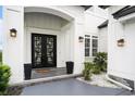 Close-up of the home's modern front entrance with a beautiful door and manicured landscaping at 1279 Fiddlehead Way, Myrtle Beach, SC 29579