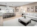 Stylish living room open to the kitchen, with an island, plush seating, and neutral decor at 1324 Piper Glen Dr, Sunset Beach, NC 28468