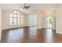 Bright living room boasts gorgeous laminate flooring and a large arched window for natural light at 1435 Saint Thomas Circle # E-1, Myrtle Beach, SC 29577