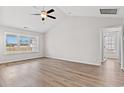 Spacious bedroom with vaulted ceilings, ceiling fan, wood-look floors and plenty of natural light at 154 Six Mile Creek Dr., Georgetown, SC 29440