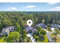 Stunning aerial view of the neighborhood, showcasing lush greenery and well-maintained properties at 154 Windsor Circle Sw, Ocean Isle Beach, NC 28469