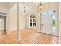 Inviting foyer with hardwood floors, arched window, tiled entrance, and a beautiful front door at 154 Windsor Circle Sw, Ocean Isle Beach, NC 28469