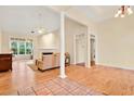 Bright living room with hardwood floors, a fireplace, and a large window for plenty of natural light at 154 Windsor Circle Sw, Ocean Isle Beach, NC 28469