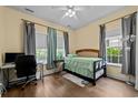 Bright bedroom with natural light, ceiling fan, hardwood floors, a desk, and neutral walls at 1614 Cottage Cove Circle, North Myrtle Beach, SC 29582