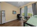Inviting bedroom features hardwood floors, a desk, natural light, and neutral paint at 1614 Cottage Cove Circle, North Myrtle Beach, SC 29582