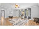 Bright living room offers neutral paint, wood-look flooring, and an open concept layout at 1894 Athens Dr., Conway, SC 29526