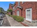 Close-up view of a brick townhouse with a manicured lawn at 2101 Firebird Ln. # 14, Myrtle Beach, SC 29577