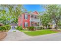 Charming two-story home with a double porch and a detached garage, showcasing its curb appeal at 212 Greenwich Dr., Conway, SC 29526