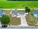 Spacious property featuring a well-maintained lawn, storage building, and charming single story home at 212 Sweetbay Magnolia St., Loris, SC 29569
