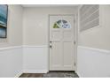 Bright foyer with white wainscoting, a decorative rug, and a door with a window at 217 N Myrtle St. # 1, Myrtle Beach, SC 29577