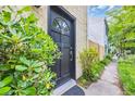 Inviting front door with decorative window, surrounded by lush greenery at 217 N Myrtle St. # 1, Myrtle Beach, SC 29577