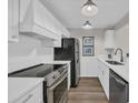 Modern kitchen features stainless steel appliances, white cabinets, and quartz countertops at 217 N Myrtle St. # 1, Myrtle Beach, SC 29577