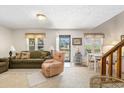 Cozy living room featuring lots of natural light, plush seating and stairway at 2191 Liberty Circle, Little River, SC 29566