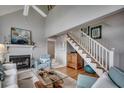 Bright living room features high ceilings, fireplace, and staircase leading to a loft area at 24 Frigate Ct., Pawleys Island, SC 29585