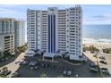 Exterior shot of the condominium building near the beach with an expansive parking lot at 2511 S Ocean Blvd. S # 1802B, Myrtle Beach, SC 29577