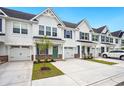 Beautiful townhouses with white siding, blue shutters, and well-manicured landscaping at 253 Bent Green Ct. # 70D, Murrells Inlet, SC 29576