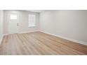 Bright living room with wood-look flooring and a white door at 253 Bent Green Ct. # 70D, Murrells Inlet, SC 29576
