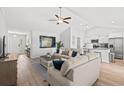 Open concept living space combining a cozy living room with a modern kitchen and dining area at 259 Stillbrook Dr., Longs, SC 29568
