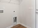 A bright laundry room with a hookup for the washer and dryer and a shelf for storage at 263 Stillbrook Dr., Longs, SC 29568